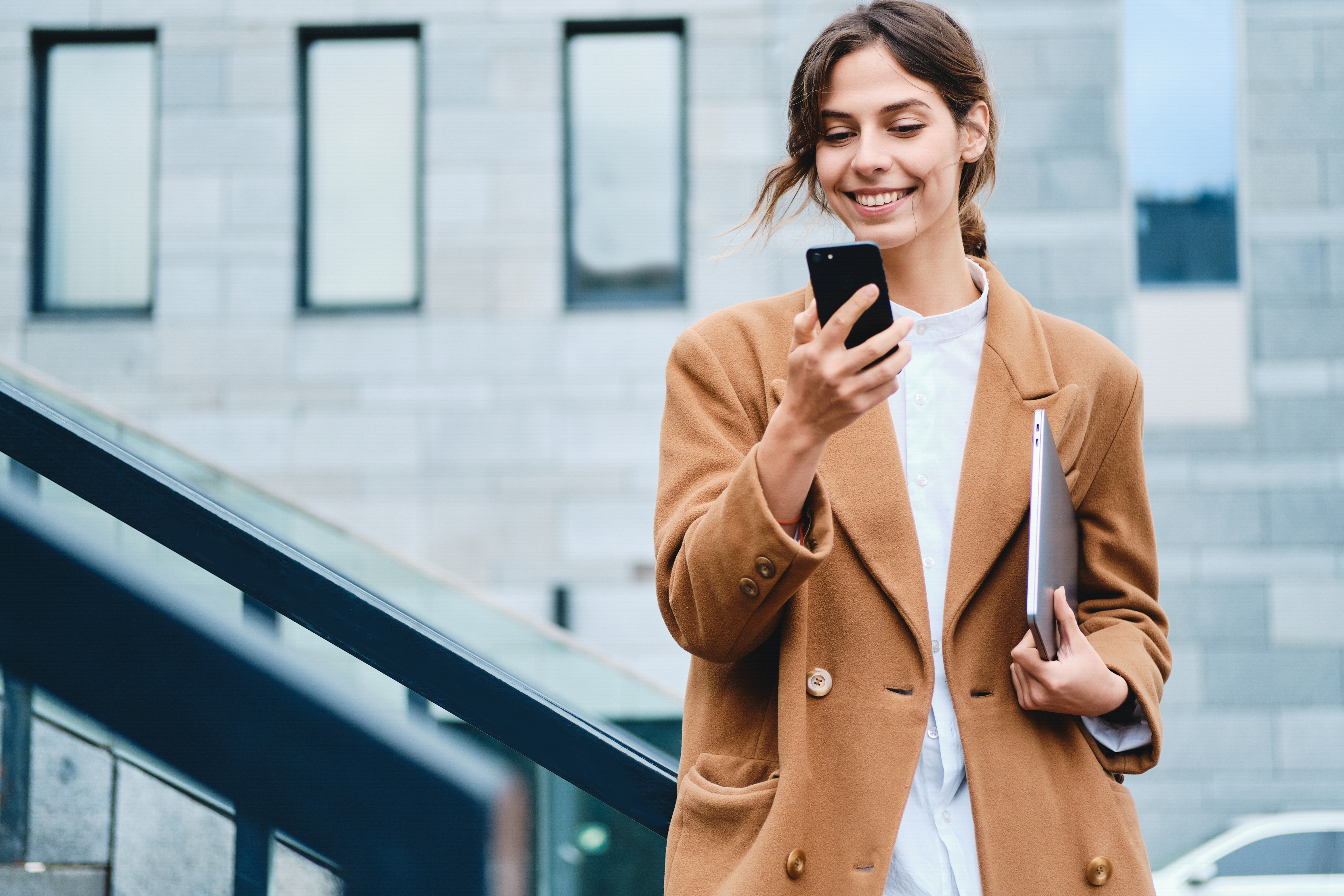 Woman in beige coat is happy