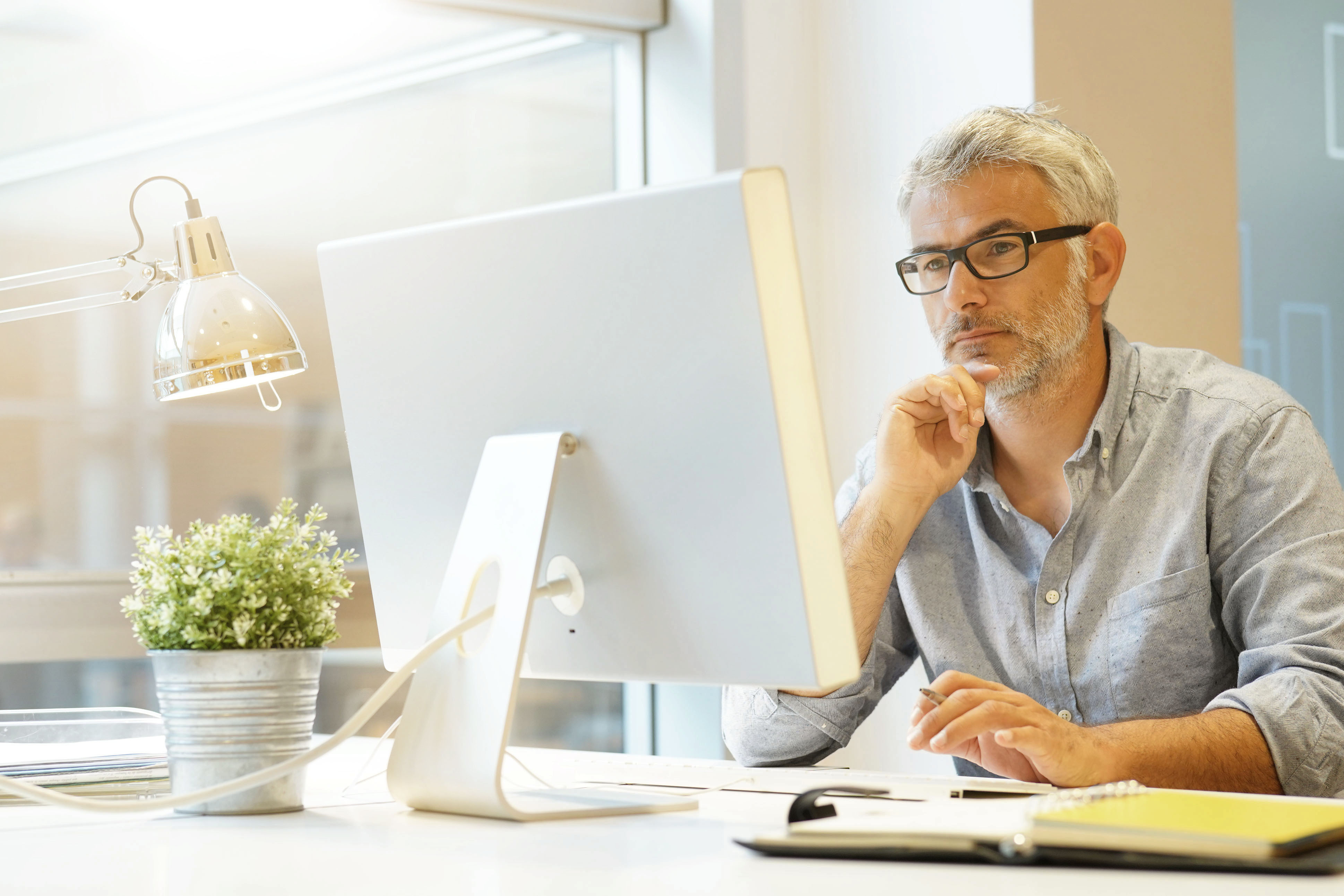 Man looks thoughtfully at his screen